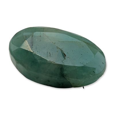 Loose Oval Faceted Emerald Gemstone. Oval faceted green gemstone appearing to be an emerald. The 