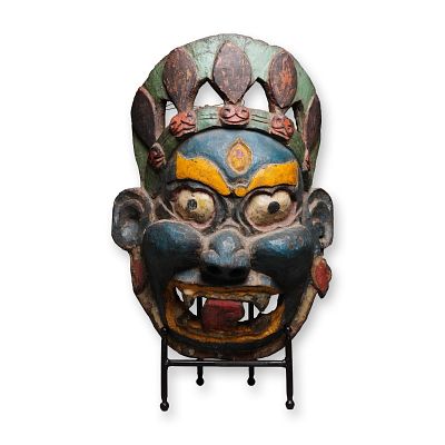 Large Tibetan Carved Wood and Polychrome Mask of a Demon. A large carved wooden mask depicting a 