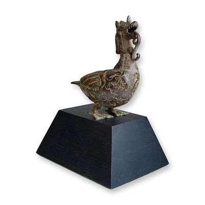 Indonesian Bronze Figure of a Dragon Bird on Wood Display Base. A bronze figurine depicting a 