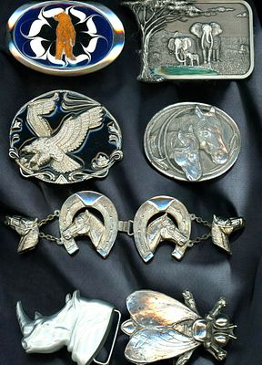 A CARD OF ASSORTED WHITE METAL BUCKLES. 7 Heavy and large pictorial animal buckle. From the 