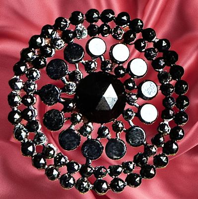 A DIVISION ONE PIERCED RIVETED BLACK GLASS BUTTON. 1 Large 19th century multi size and shaped 