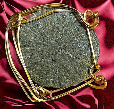 A DIVISION THREE GEMSTONE SET IN GOLD. A Large 20th century hand crafted twist setting. From the 