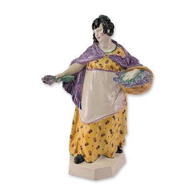 Charles Vyse Chelsea Pottery Figurine, The Lavender Girl. The woman is portrayed in traditional 