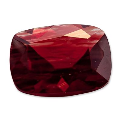 Cushion Cut Red Stone. A faceted cushion cut stone, exhibiting a deep and saturated red color 