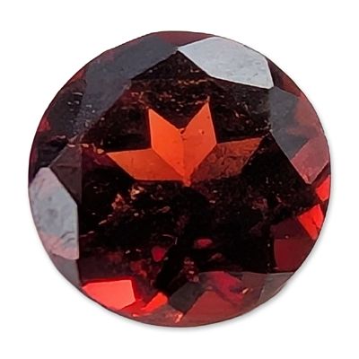 Round Brilliant Cut Red Garnet. A loose round brilliant cut red gemstone, which appears to be a 