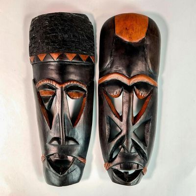 Pair of African Hand Carved Wooden Tribal Wall Masks. Black stained wood masks with carved out 