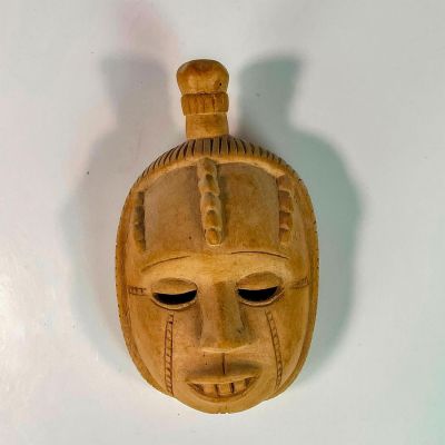 African Hand Carved Wooden Tribal Wall Mask. Carved out eyes and decorated with chiseled swirl 