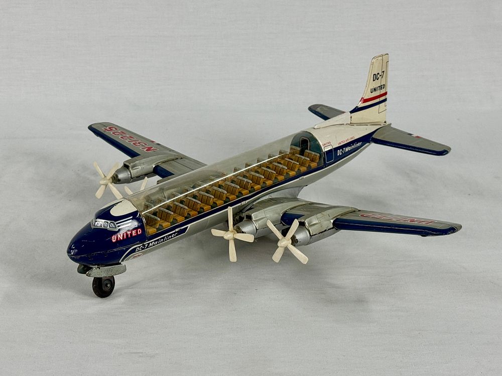 Lot 355: Vintage T.N. United Airlines DC-7 Mainliner Toy Propeller Airplane