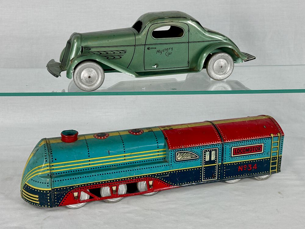 Lot 369: A Pair of Wolverine 'Mystery Car' and 'LOCOMOTOR' Tin Toys