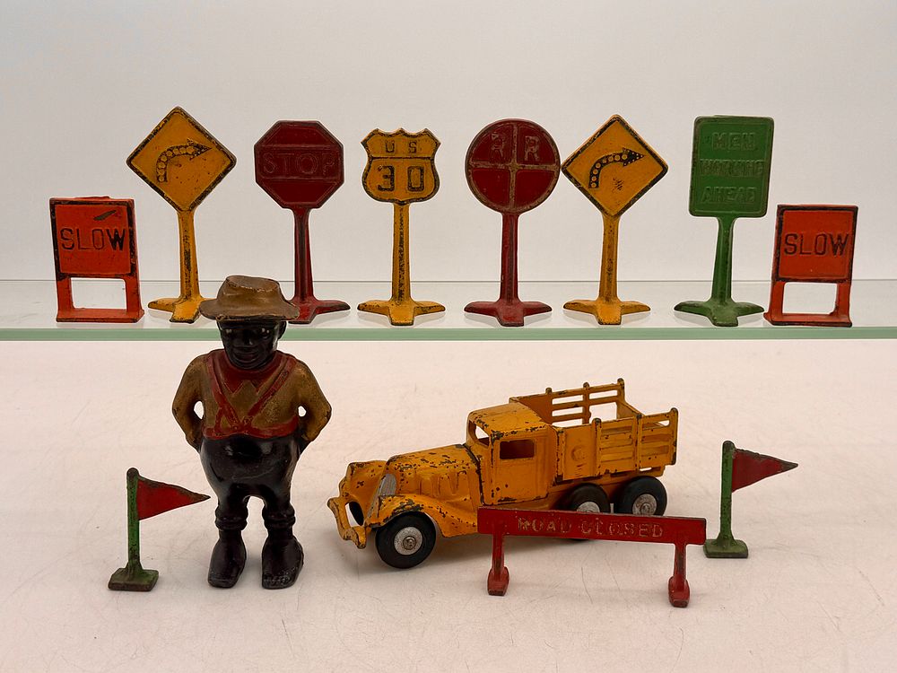 Lot 446: A Collection of Arcade Cast Iron Road Signs, Bank, and Toys