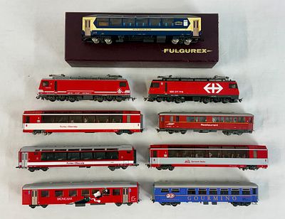 9 Swiss HOm Scale Model Locomotives and Passenger Carriages. This collection consists of nine 