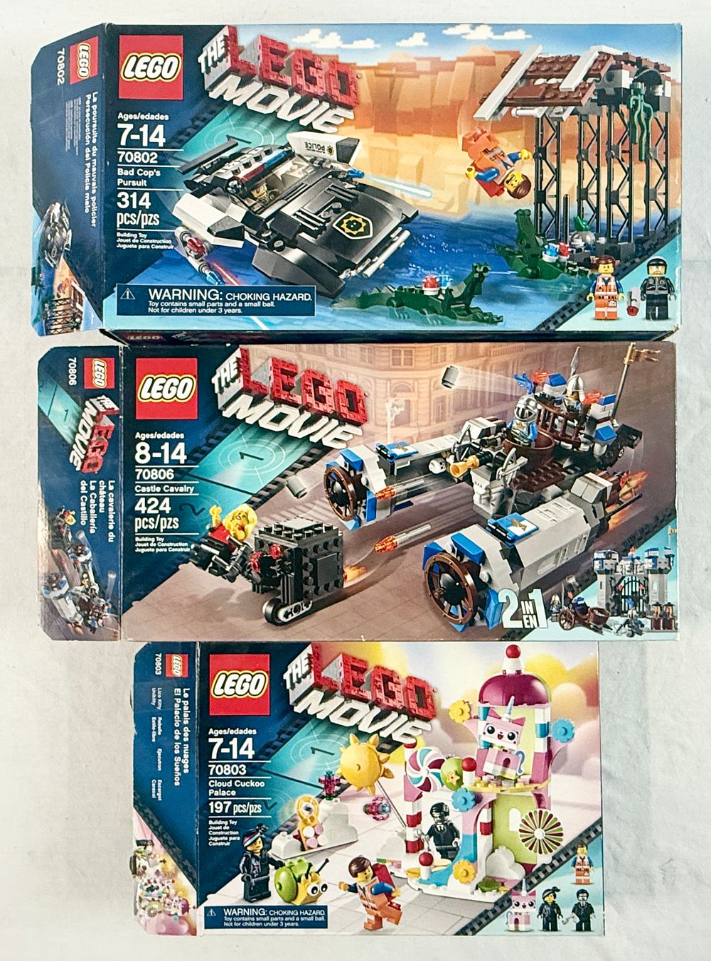 Lot 201: Three The LEGO Movie Construction Sets including 70802 Bad Cop's Pursuit, 70806 Castle Cavalry, and 70803 Cloud Cuckoo Palace