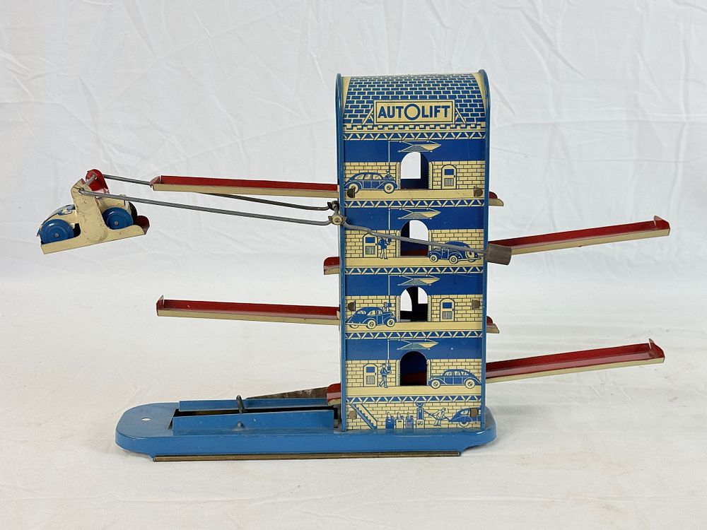 Lot 494: Wolverine Auto Lift Tin Lithograph Wind-Up Toy with Car