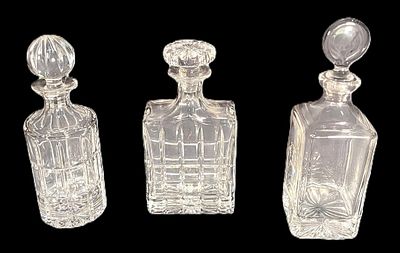 THREE CRYSTAL CUT GLASS DECANTERS. Height: 11 in. by Width: 5 in. by Depth: 4 in.