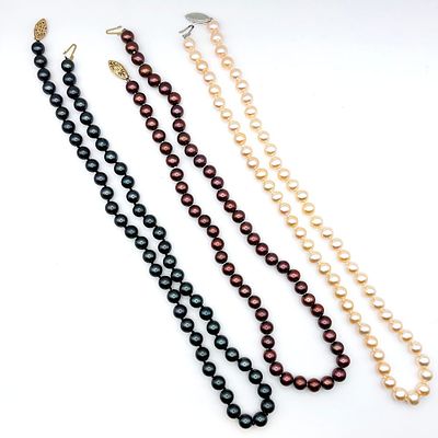 Three 14K Brown, Peach, Black pearl necklaces. Each necklace has a 14K gold clasp and measures 