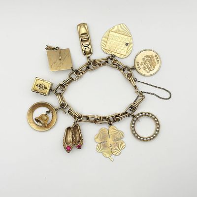Vintage 14K Gold Charm Bracelet with Nine Charms. Vintage 14K yellow gold charm bracelet with 