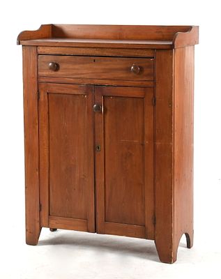 A Pennsylvania Softwood Cupboard, c. 1830 
The galleried top above a single drawer over 