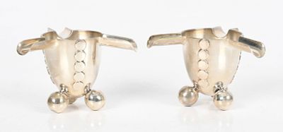 A Pair of William Spratling Sterling Silver Ashtrays 
Each with three ball feet 