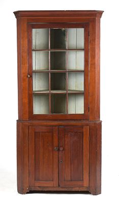 A Federal Pennsylvania Cherrywood Two-Part Corner Cupboard, c. 1810 
With an 