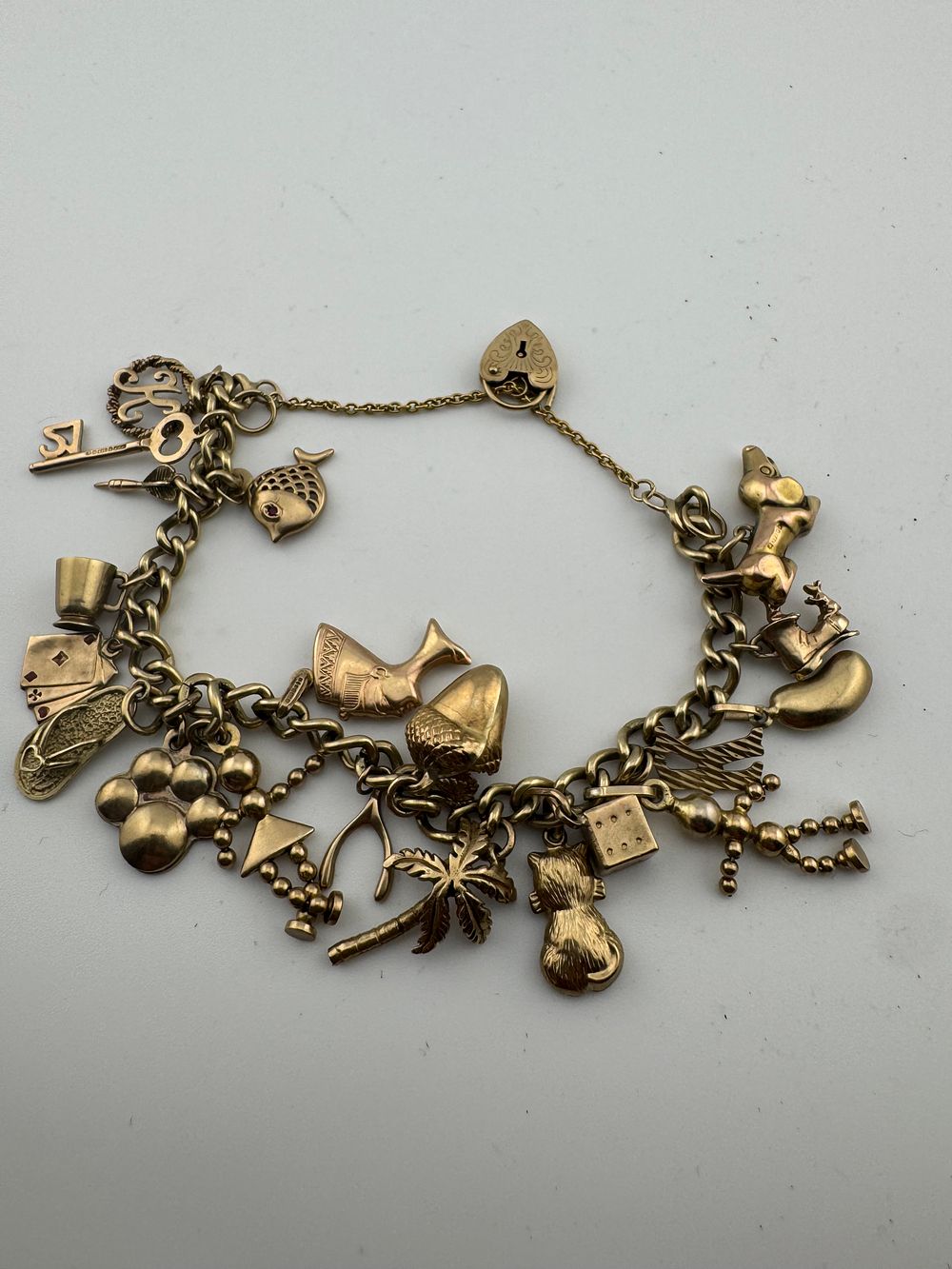 Lot 205: 9ct gold charm bracelet with charms.