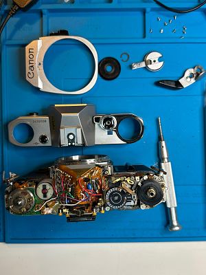 A Canon AE-1 35mm SLR Camera. Canon AE-1 Film SLR / FD 100mm f/4 Macro Lens – Fully Functional 