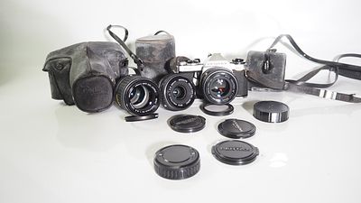 A Pentax mv with 50mm f1.7 / 28mm f2.8 / 135mm f3.5 shutter / aperture working lenses clear