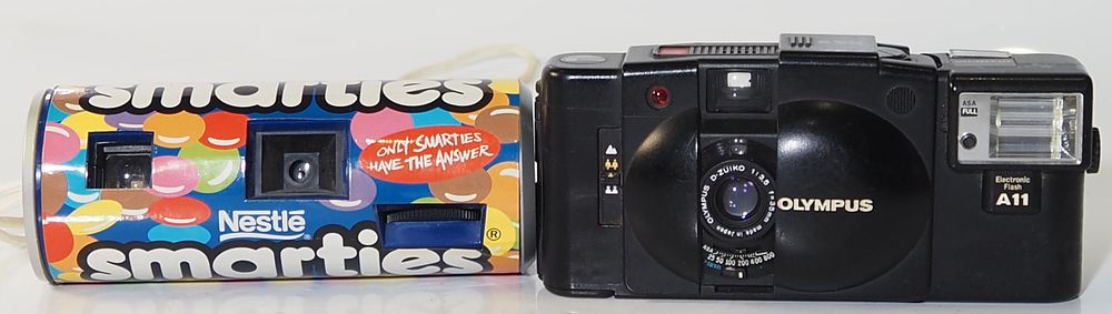 Lot 190: A Olympus XA2 flush working camera battery connection rusted  plus smarties camera