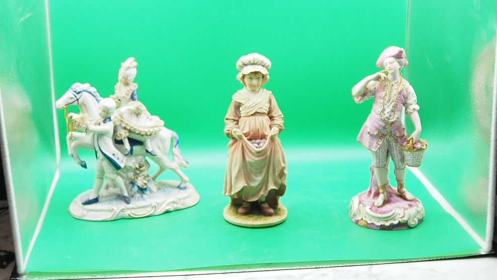 Lot 220: A collection of six vintage porcelain figurines in the European tradition