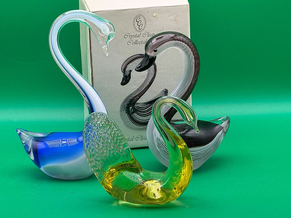 Lot 269:  Three Crystal Clear Collectables Art Glass Swans Blue White Striped and Amber Greix