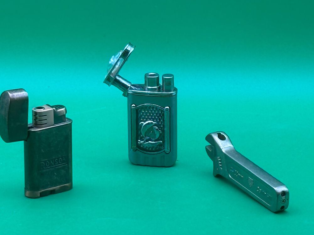 Lot 317: Three Lighters and Novelty Wrench Shaped Lighter Ronson and Dolphin Design