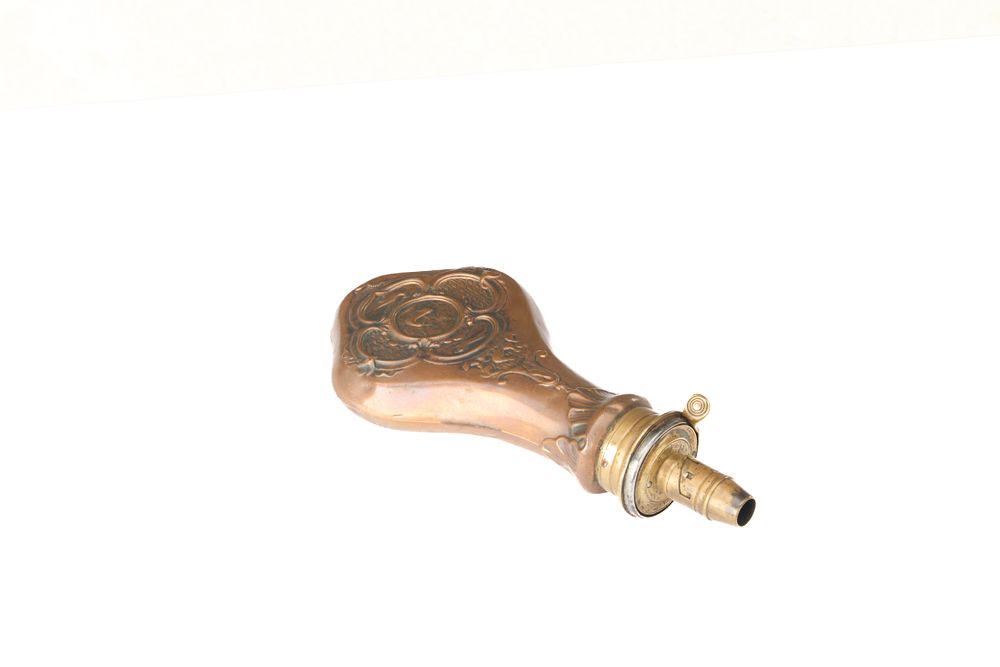 Lot 528: A PATENT TOP COPPER AND BRASS POWDER FLASK BY 'G & J.W.R' FIRE PROOF. BODY EMBOSSED WITH DOGS, BIRDS AND DEER. 2.5 - 3 DRAMS. SOME DENTS. GRADE 2.