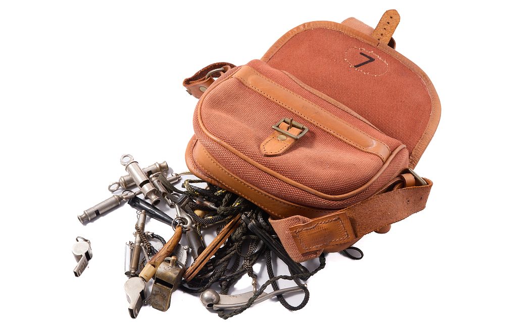 Lot 1502: ASSORTED CALLS AND WHISTLES IN LEATHER POUCH