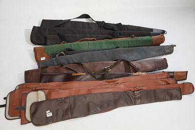 Twelve assorted gun slips. Five canvas and seven leather.