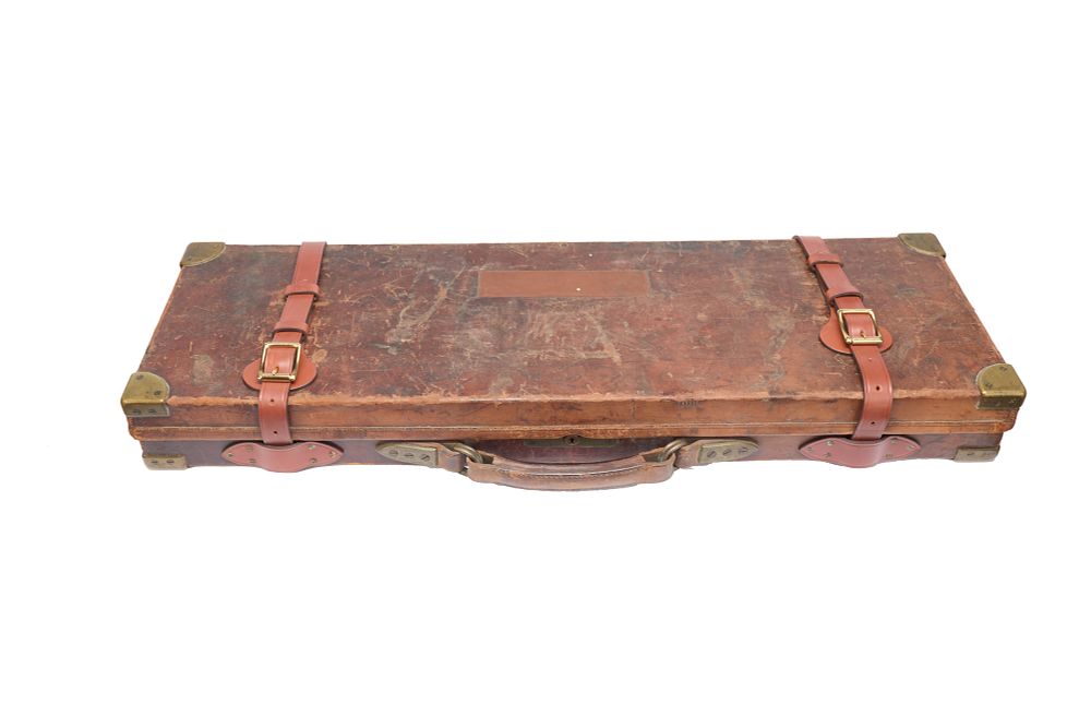 Lot 101: WILLIAM POWELL A LEATHER AND OAK CASE WITH BRASS CORNERS.

 With key, cleaning rods and replaced straps.