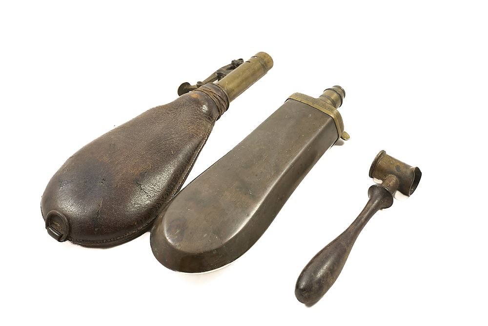 Lot 64: TWO POWDER FLASKS, LEATHER & BRASS, & POWDER MEASURE;