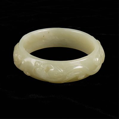 Chinese Modern Carved Jade Bangle. Chinese modern carved jade bangle with a dragon design. 