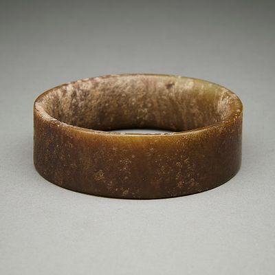 Chinese Carved Brown Unpolished Jade Bangle. Chinese carved brown jade bangle or bracelet. With 