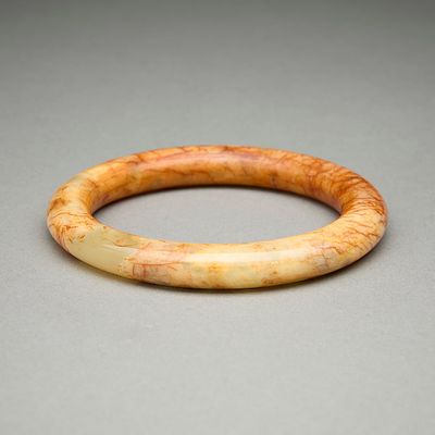 Chinese Carved Jade Bangle w/ Russet Inclusions. Chinese carved opaque jade bangle bracelet with 