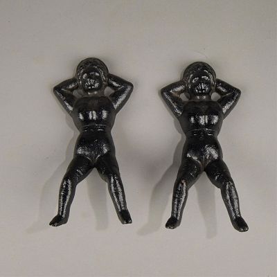 Pair Cast Iron Lady Bootjacks. Pair of cast iron boot jacks in the form of recumbant ladies. 
