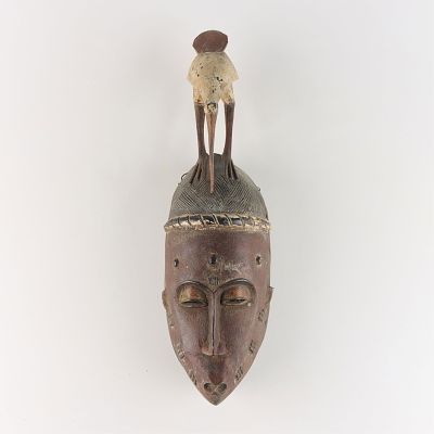 Baule or Yaoure African Mask Carving. Carved African mask with a bird form crest, likely carved 