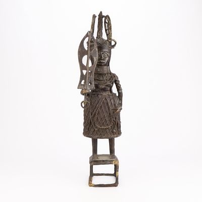 Benin Bronze Sculpture. Benin bronze sculpture depicting a figure on a platform.Incised along 