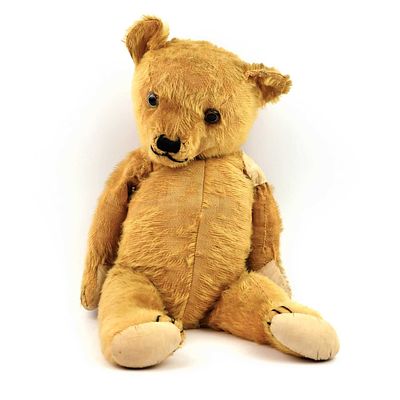 AN EARLY 20TH CENTURY TEDDY BEAR in used condition, 60cm tall. Wear commensurate with use and age