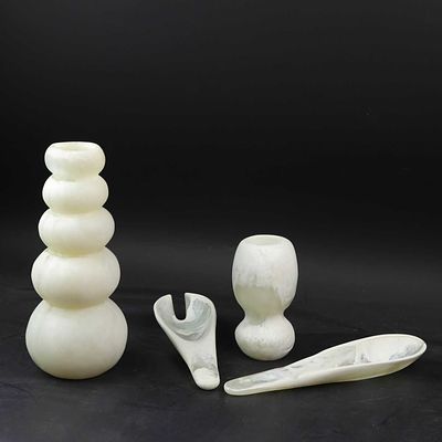 ASSORTED ITEMS FROM DINOSAUR DESIGNS (4) comprising two resin vases, one 30 cm h the other 16 