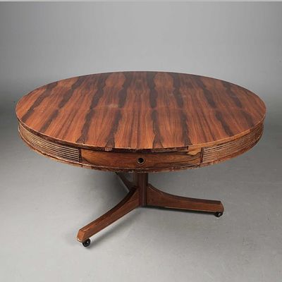 MID 20TH CENTURY DRUM TABLE circa 1970, with four drawers on castors, 78cm H x 140cm D. faults