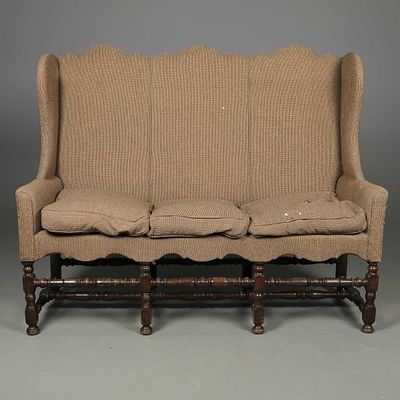 JACOBEAN STYLE SOFA of country house proportions with high-shaped backs on wooden supports on 