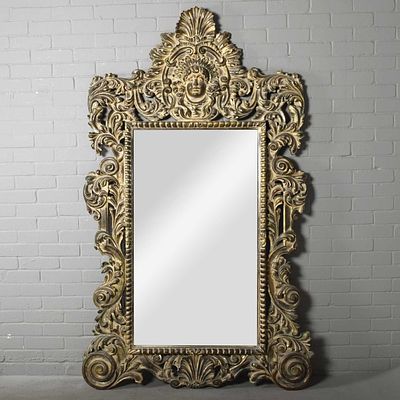 ROCOCO STYLE WALL MIRROR carved and gilded with mask and foliate scrolling frame, 206cm H x 122cm W.