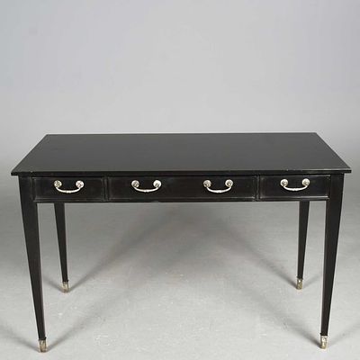 WRITING TABLE black lacquer with three frieze drawers on square tapering supports and castors 