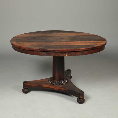 WILLIAM IV ROSEWOOD BREAKFAST TABLE circular tilt top on brass castors, 74cm H x 121cm D. faults