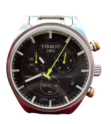 שעון כרונוגרף Tissot 1853 מפלדה, לוח שחור עם תתי-לוחות ומחוג שניות בצבע צהוב. רצועת מתכת 