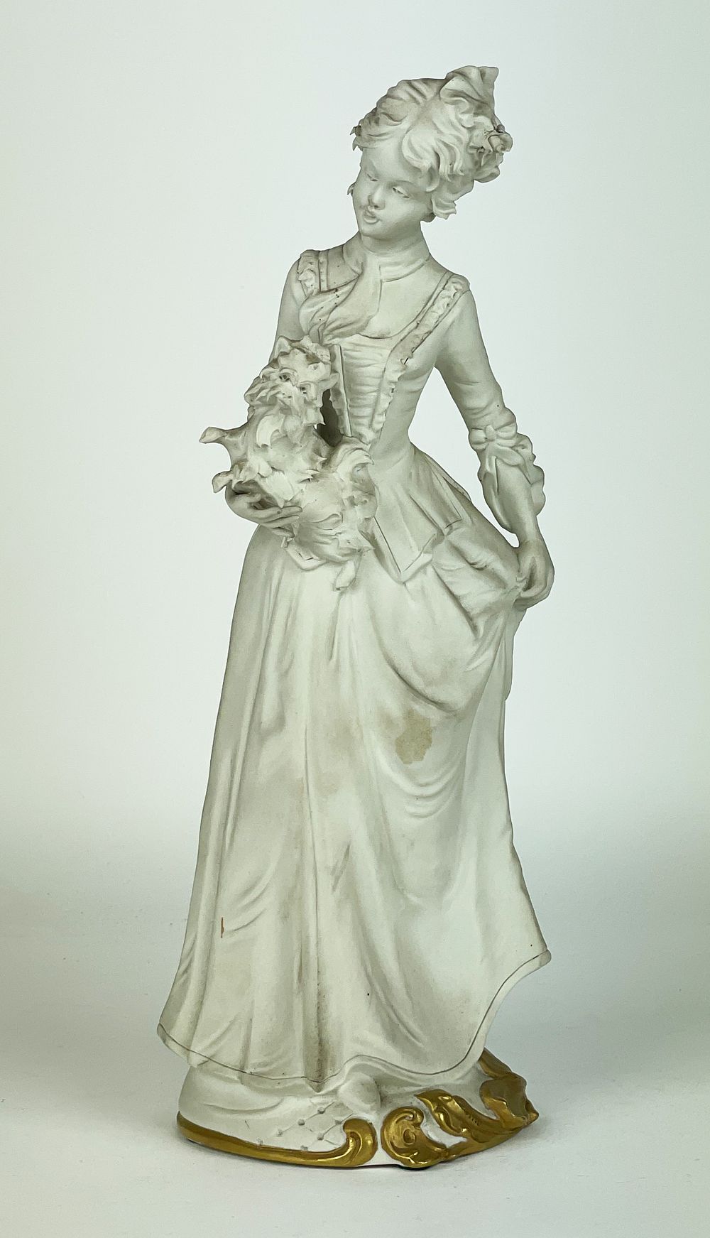 Biscuit artistic porcelain sculpture depicting a lady with a little dog, marked Capodimonte 